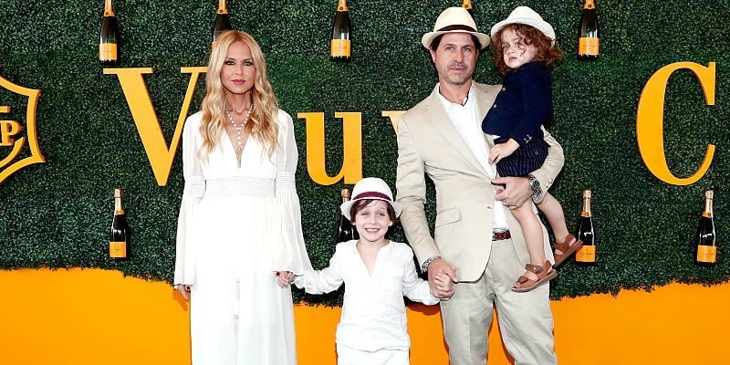 Rachel Zoe, Skyler Morrison Berman, Rodger Berman and Kaius Jagger Berman hold hands on the red carpet.
