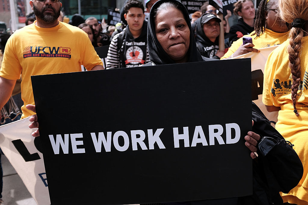 protesters with a "we work hard" sign