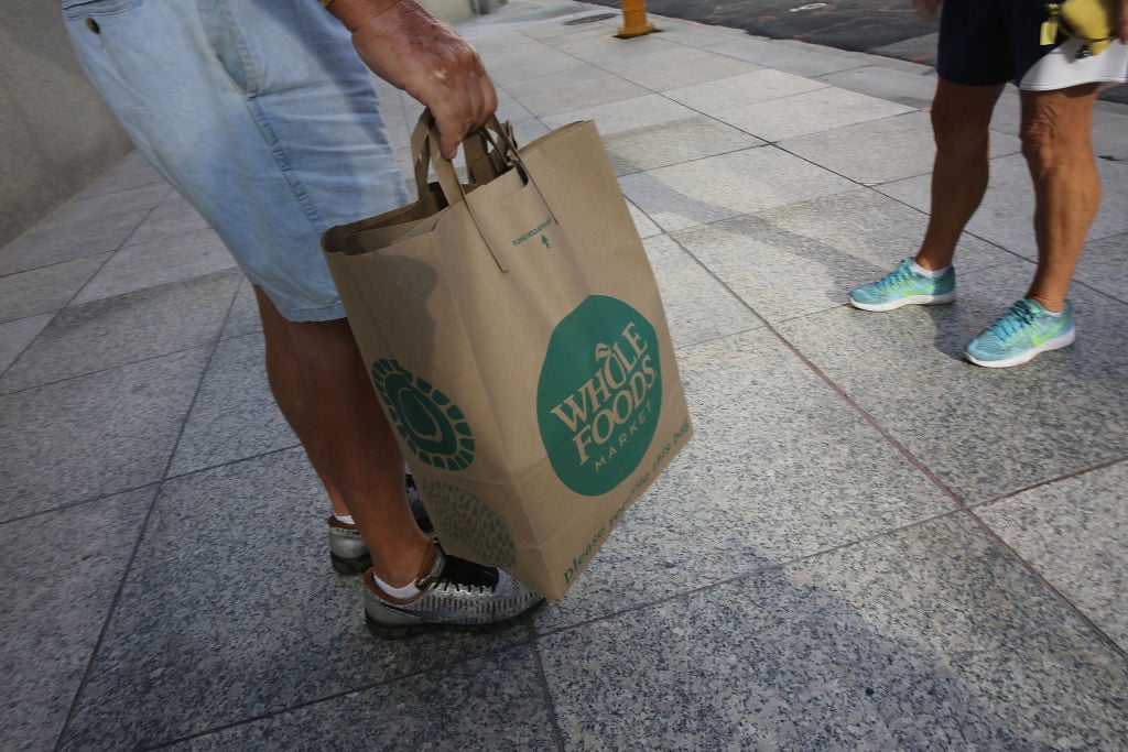 A customer with a Whole Foods Market shopping bag