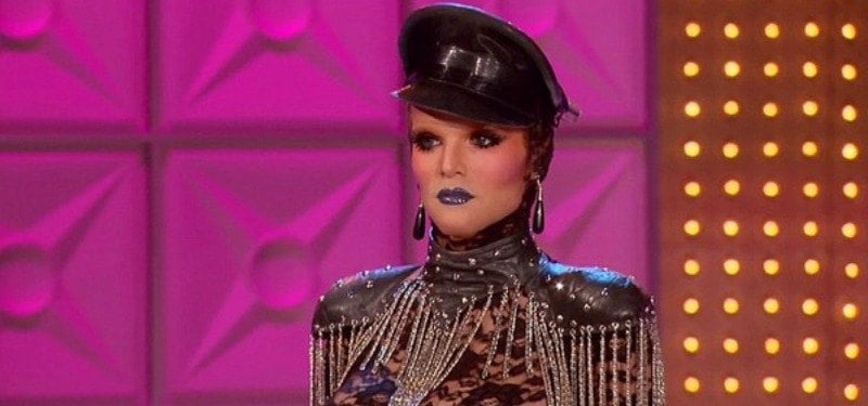 Willam is dressed in a bodysuit and hat.