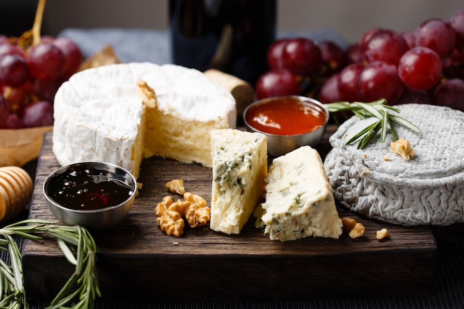 Cheese plate served with wine, jam and honey