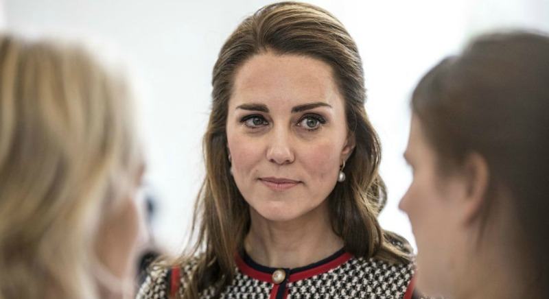 Kate Middleton looks serious as she is looking at another woman.