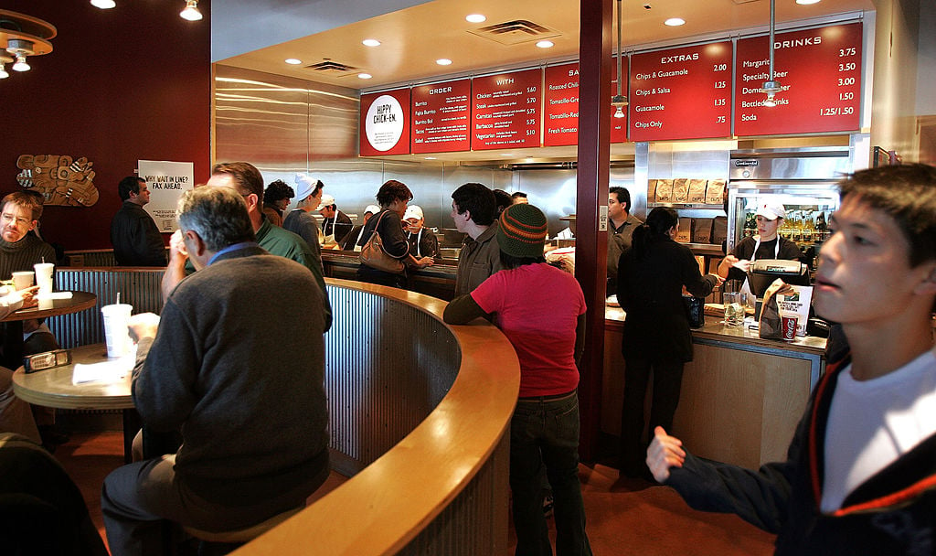 Activity is seen near the order-counter area inside a Chipotle restaurant