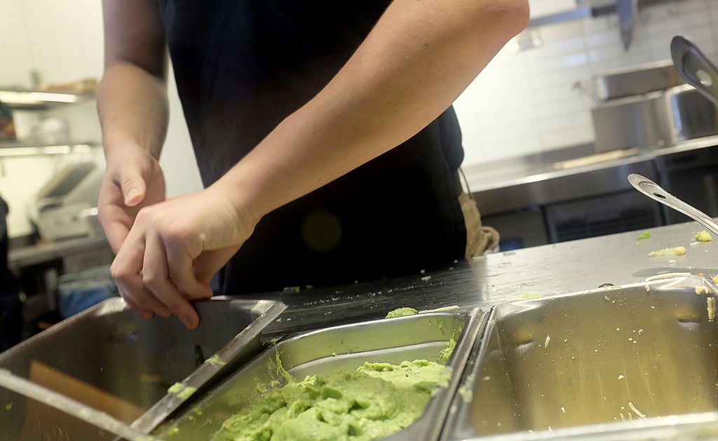 Guacamole is seen in a tin at a Chipotle restaurant