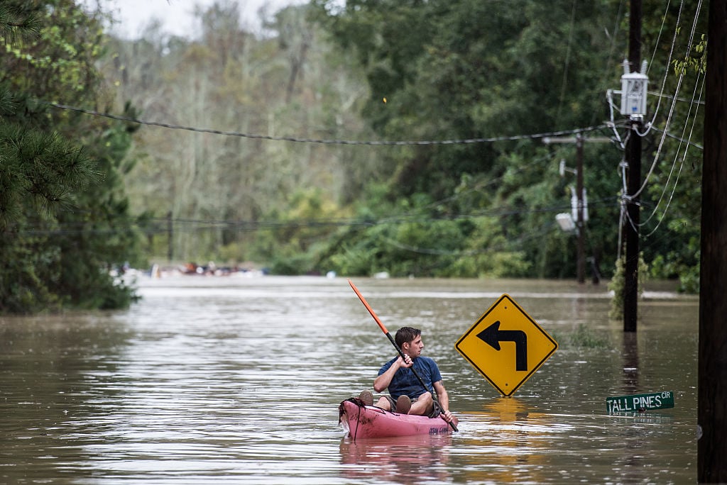 A man paddles around during a flood in South Carolina