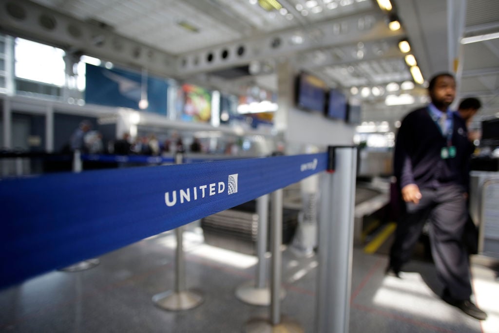 An airport worker walks through the United Airlines terminal at O'Hare International Airport