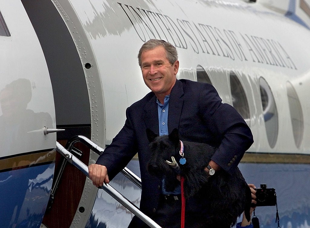 US President George W. Bush holds his pet dog Barn