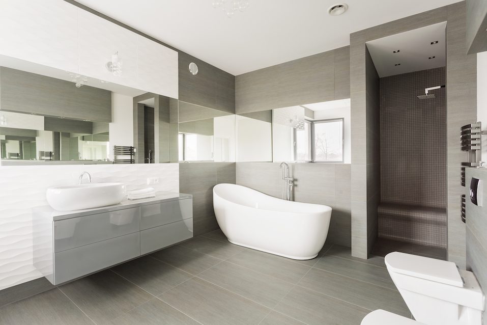 White and grey exclusive big washroom with fancy bath