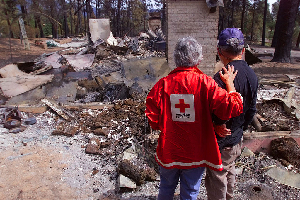 red cross volunteer comforts fire victim