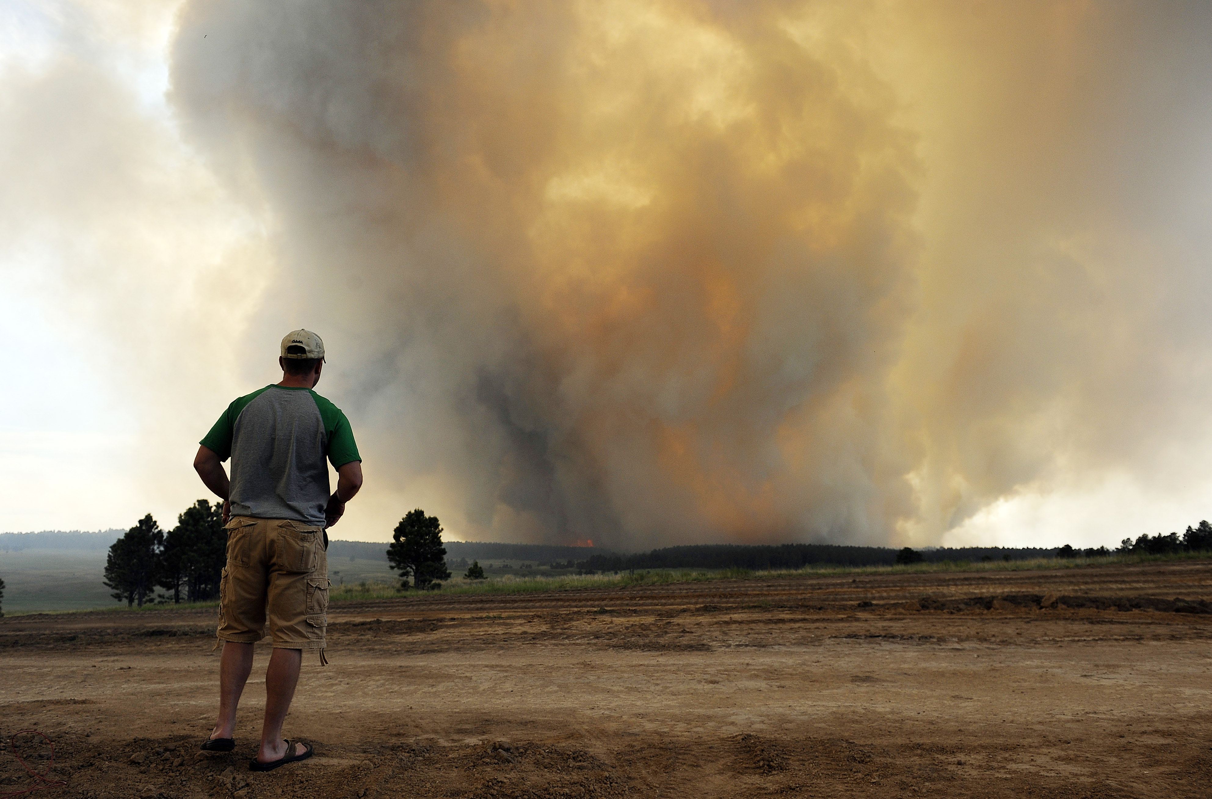 man watches approaching fire