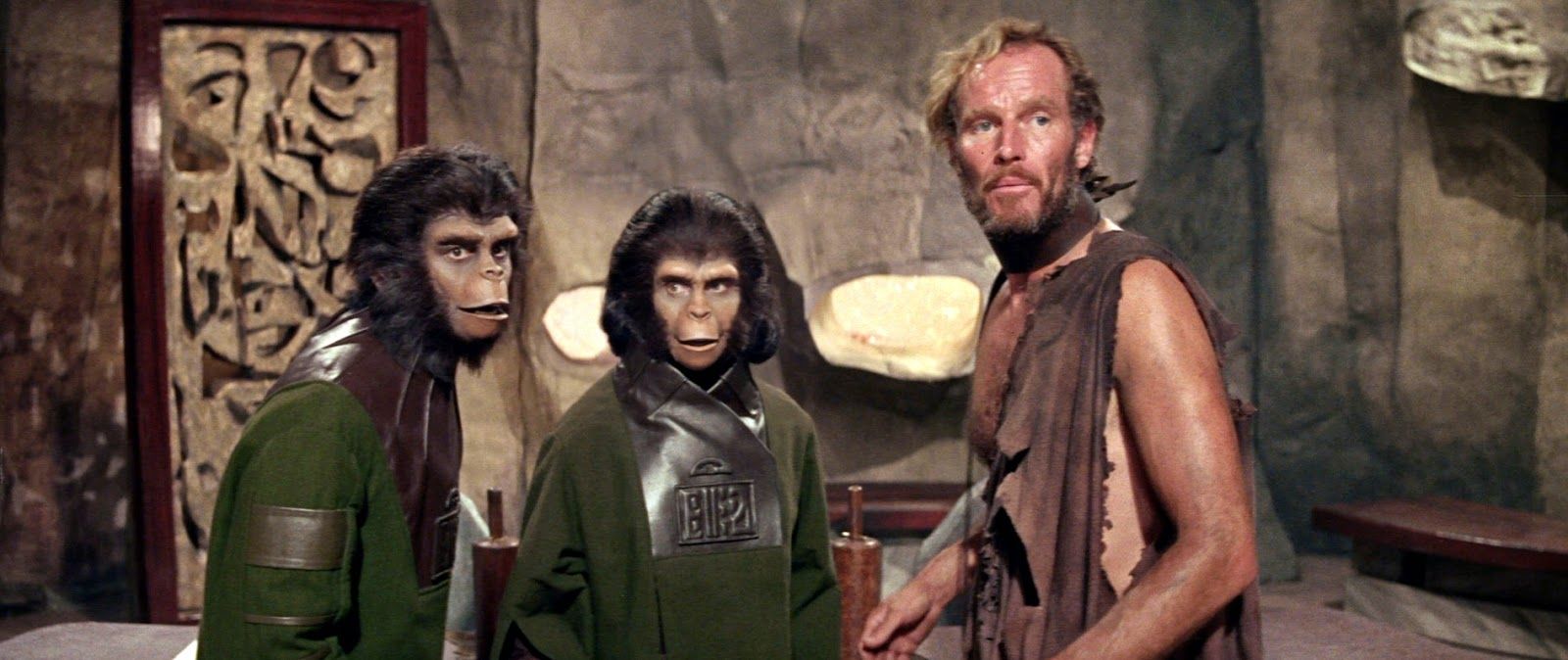 Two apes and a man standing together