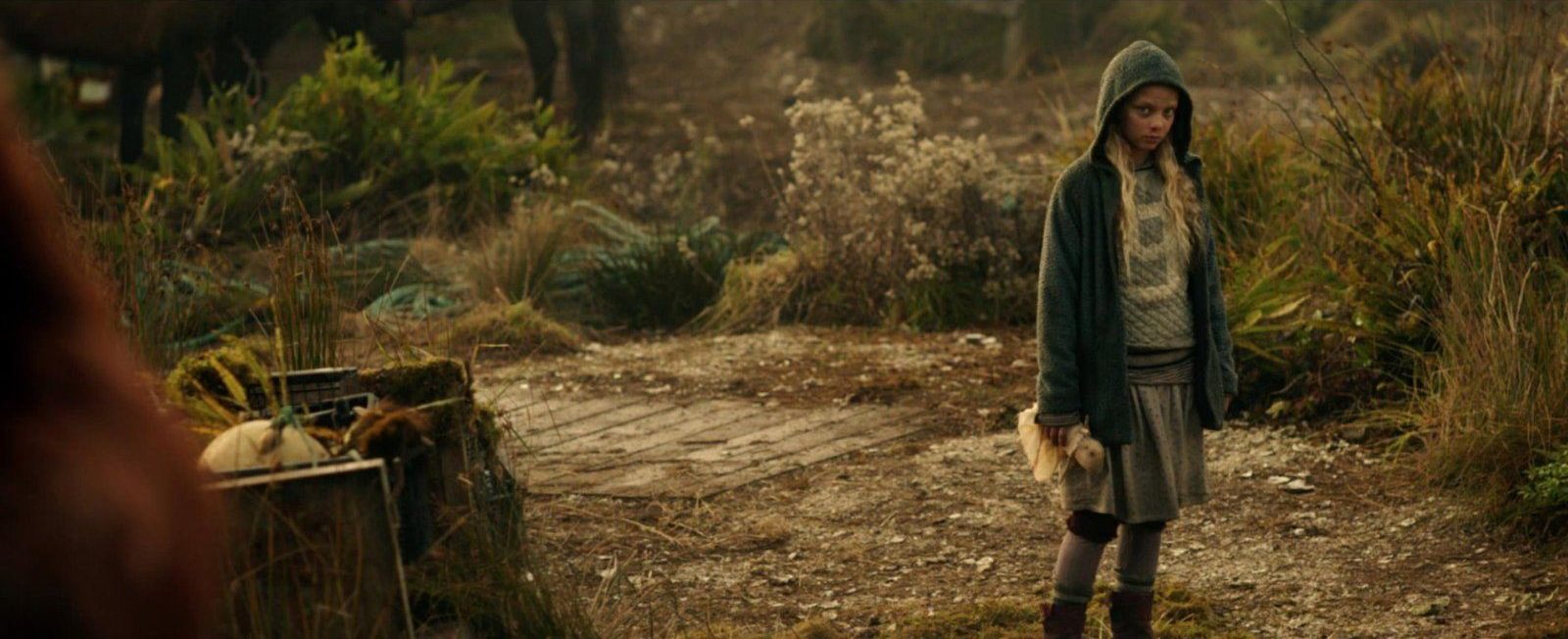 Amiah Miller in a hooded sweatshirt looking sad