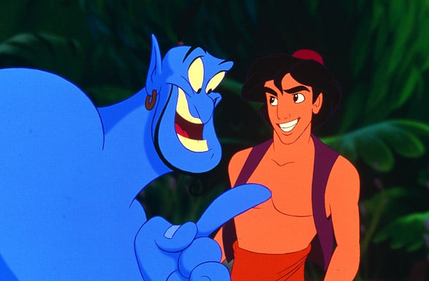 The Genie pointing and laughing at Aladdin, who smiles and stares back at him.