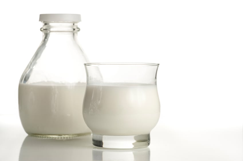 glass of milk next to a glass jug