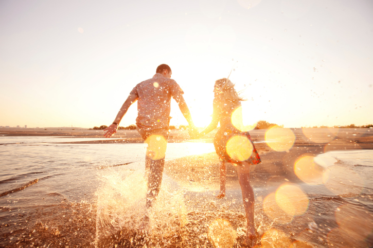 Couple holding hands at the beach