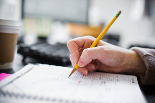 A person writing down a budget