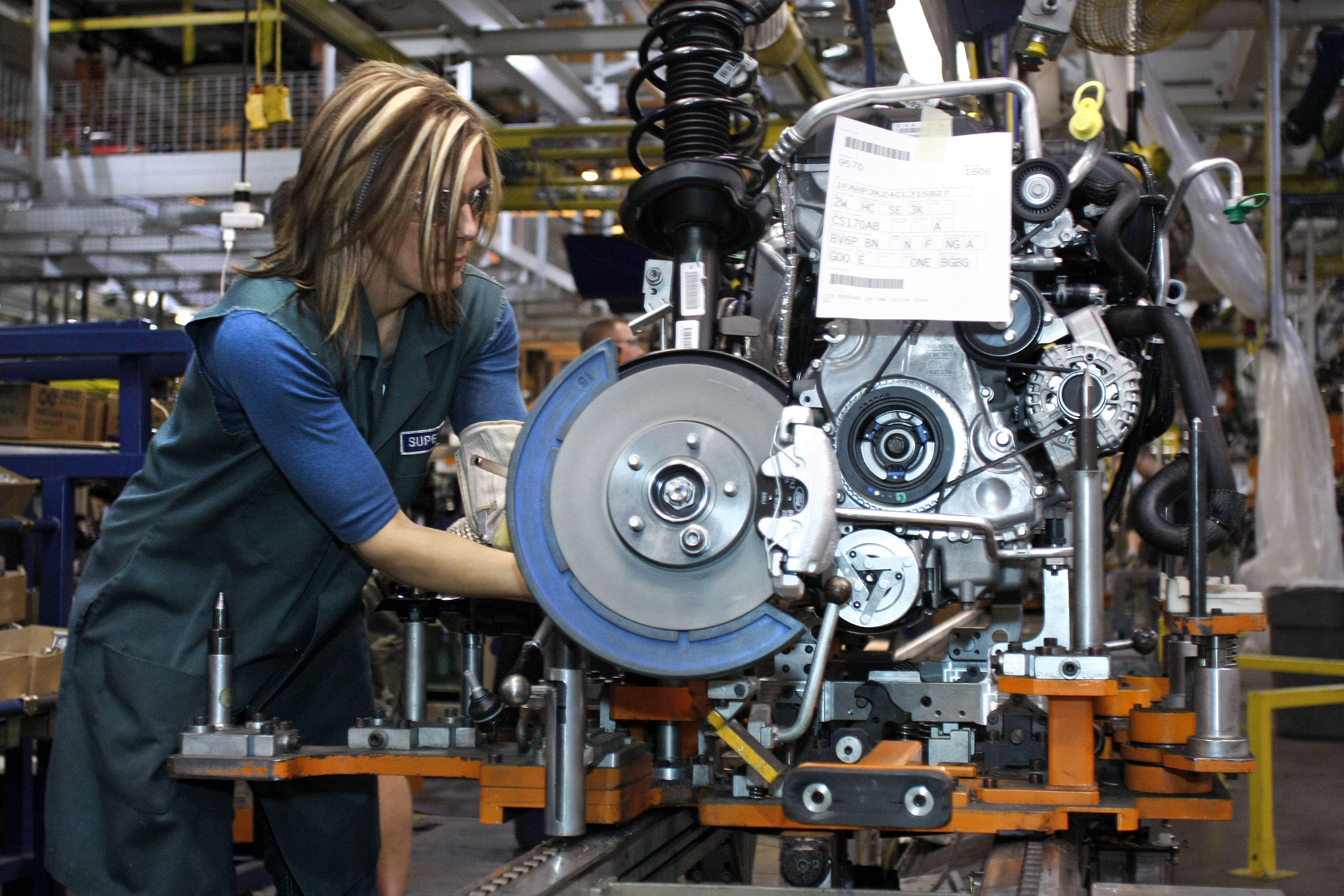 A worker builds an engine for a 2012 Ford Focus on the assembly line at the Ford Motor Co.'s Michigan Assembly Plant December 14, 2011 in Wayne, Michigan.