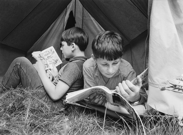 boys reading in tent