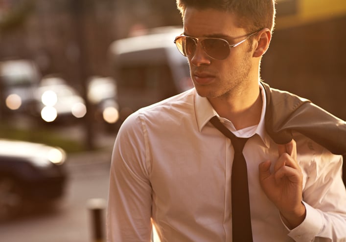a man wearing a suit and sunglasses