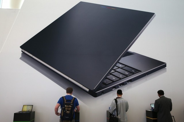 Attendees inspect the Google Chromebook Pixel laptop during the Google I/O developers conference