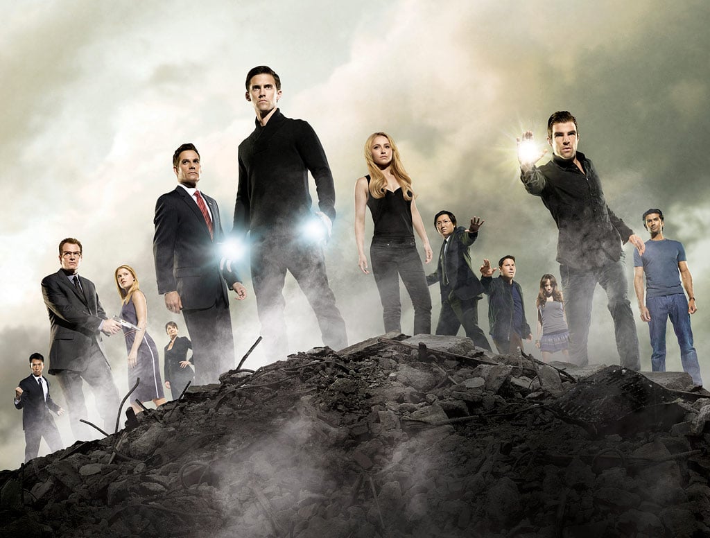 The cast of heroes standing next to one another surrounded by fog.