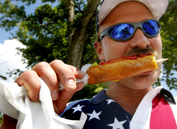 a corn dog covered in ketchup