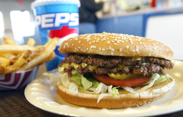 a cheeseburger with fries and a soda