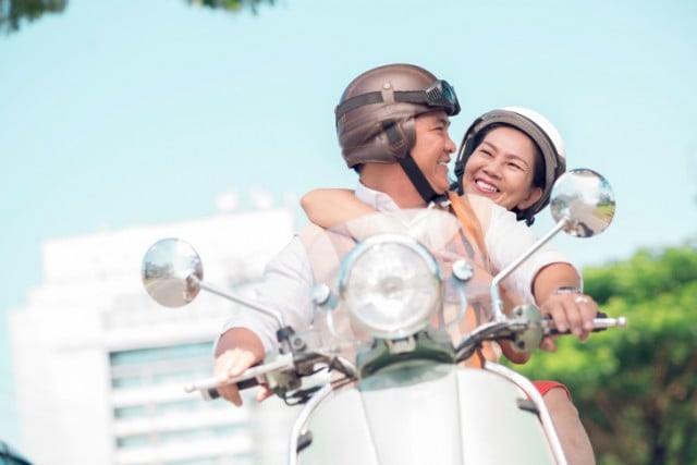 Couple riding on a scooter Couple riding on a scooter
