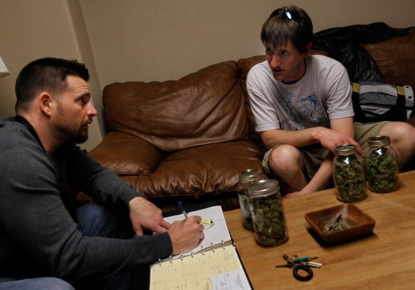 A cannabis consultant meets with clients