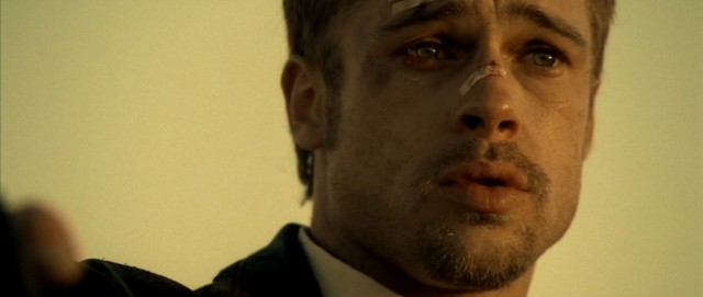 A bruised Brad Pitt wears a bandaid across his nose in Se7en
