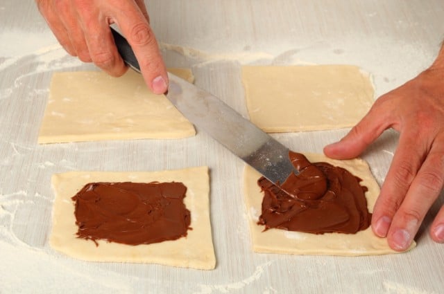 Spreading nutella on puff pastry