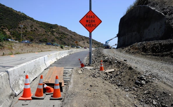 LOS ANGELES, CA - JULY 13: Construction workers reinforce the hillside during the Interstate 405 widening project near the Mulholland Bridge which is slated to be demolished during the 11 miles shut down of Interstate 405 for 53 hours starting on July 16 on on July 13, 2011 in Los Angeles, California. Los Angeles city officials are advising residents to stay home or stay away from the area over the weekend fearing massive traffic jams of what has become known as "Carmageddon." (Photo by Kevork Djansezian/Getty Images)