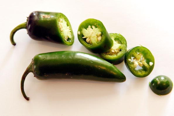 Jalapeno peppers sit on a counter top