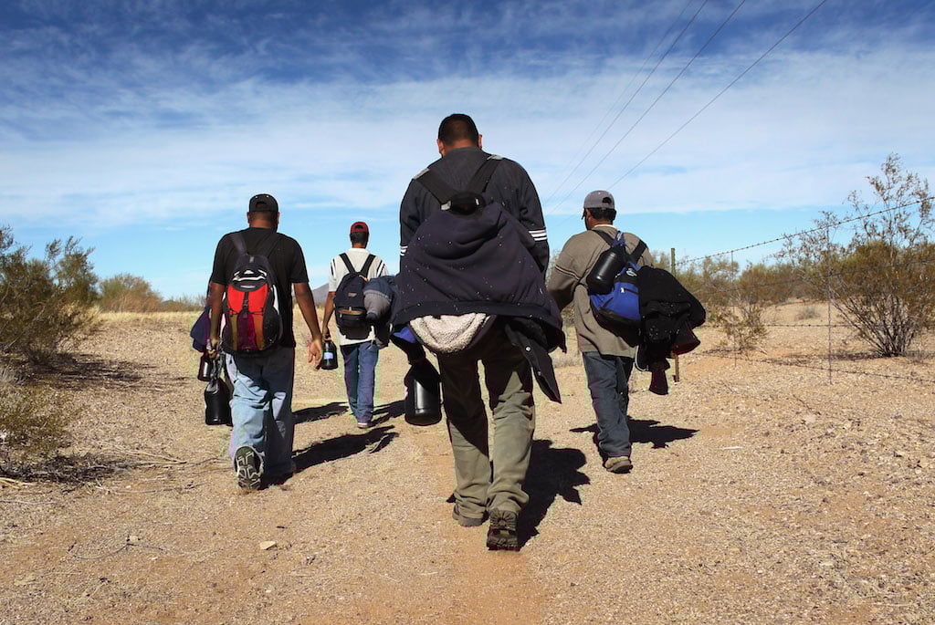 Undocumented Mexican immigrants walk through the Sonoran Desert after illegally crossing the U.S.-Mexico border border on January 19, 2011 into the Tohono O'odham Nation, Arizona. The immigrants said they had wandered the desert lost for a week after crossing from Mexico into the vast Indian reservation at night. Exhausted, they requested the Border Patrol to pick them up and take them to the U.S.-Mexico border, from where they would return to their homes in the Mexican state of Sonora. They had come, they said, to reach Phoenix and find work in construction or landscaping. All said they had worked in Arizona before. (Photo by John Moore/Getty Images)