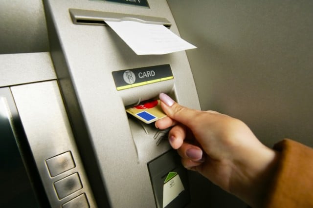 A woman uses an ATM