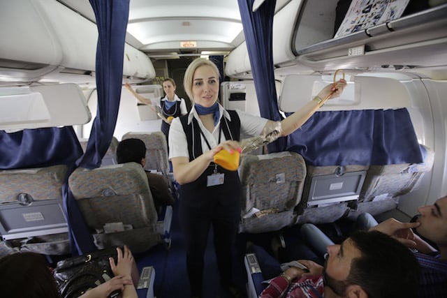 flight attendants talking to passengers