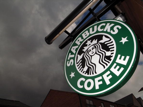 The Starbucks logo hangs outside one of the company's cafe