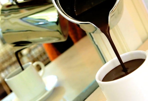 pouring hot chocolate into a mug