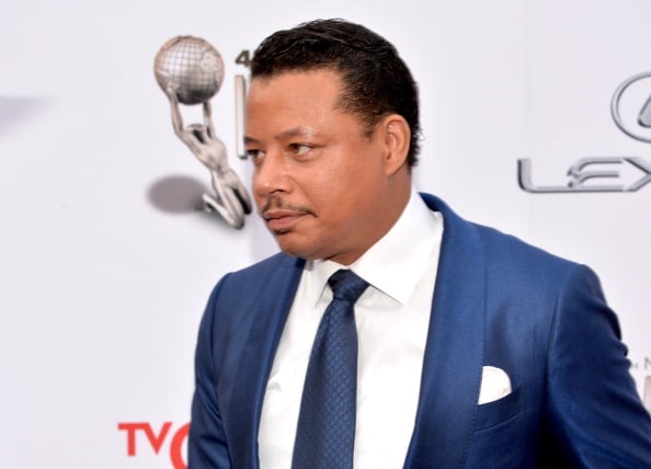 Terrence Howard is in a blue suit on the red carpet.