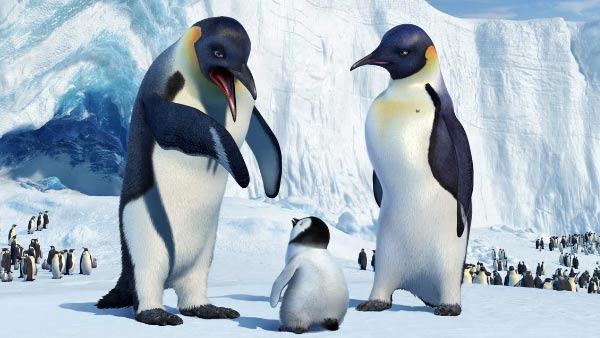 Three animated penguins stand together in a scene from Happy Feet