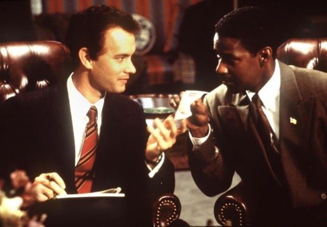 Tom Hanks and Denzel Washington talk while sitting in leather armchairs 
