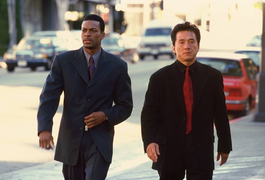 Chris Tucker and Jackie Chan walking down a street in 'Rush Hour'.