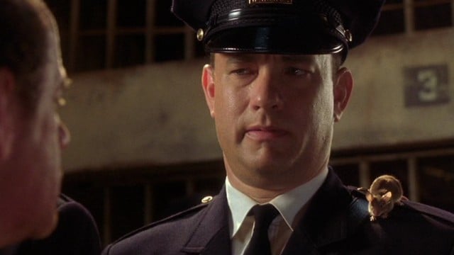 Tom Hanks wears a guard's hat and uniform in The Green Mile