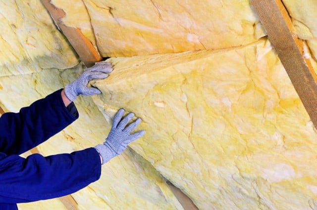 gloved person handling insulation gloved person handling insulation