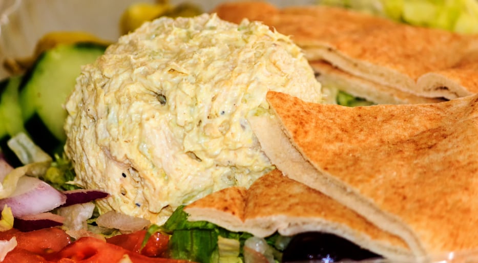 glob of chicken salad on top of vegetables with pita bread glob of chicken salad on top of vegetables with pita bread