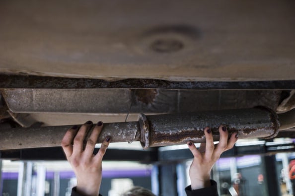 A mechanic repairs a car