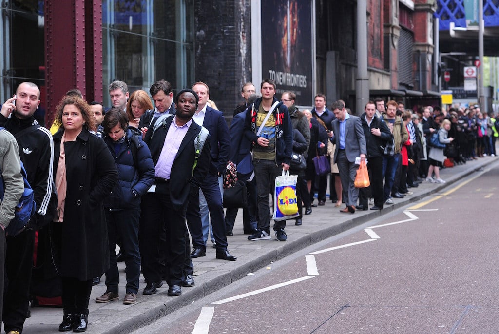 People waiting in line on the sidewalk