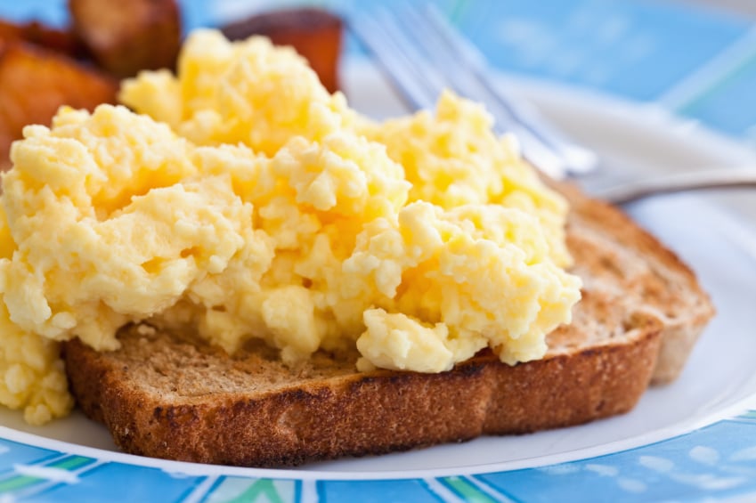 fluffy scrambled eggs on a piece of taost