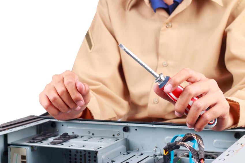 A maintenance worker fixes electronics