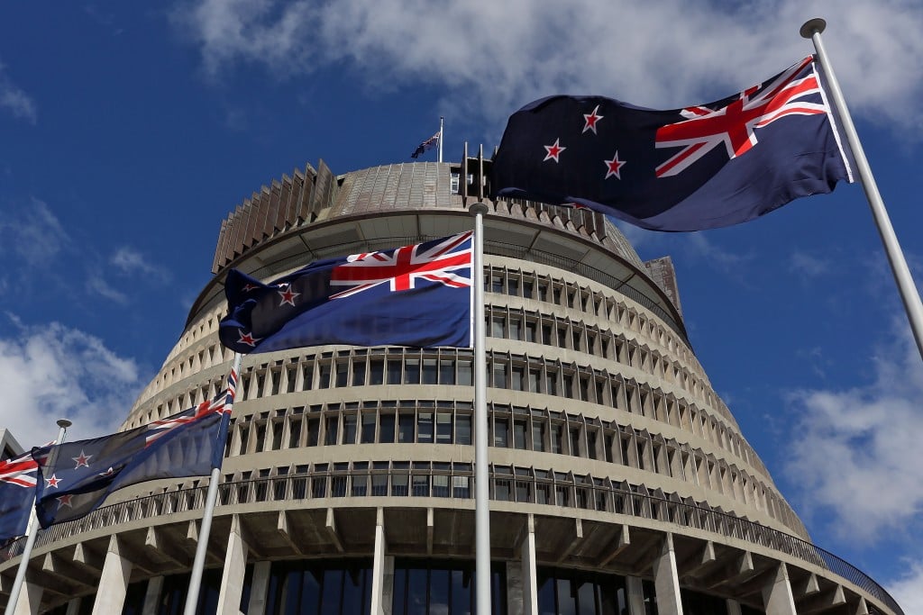 New Zealand flags fly in front of The Beehive during the Commission Opening of Parliament at Parliament.
